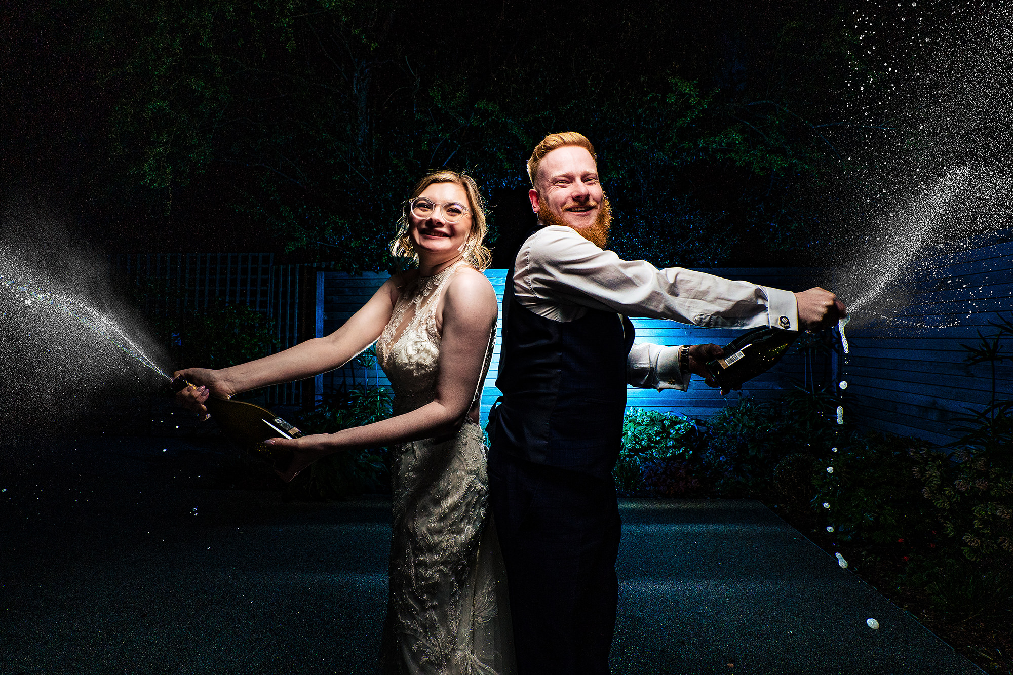 Patrick and Laurel spraying champagne to celebrate at the end of the night, Salt House wedding photographer