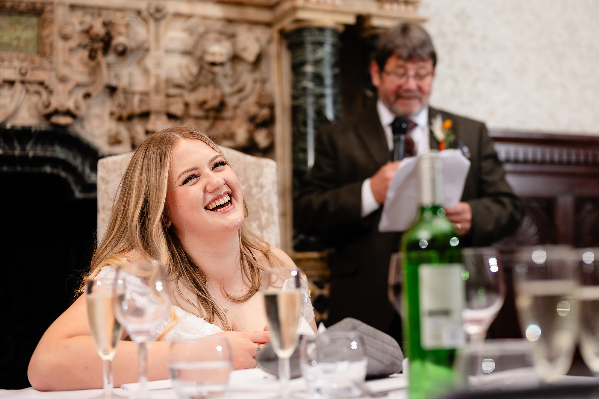 Annie laughing as her dad gives his speech, Crewe Hall wedding photographer