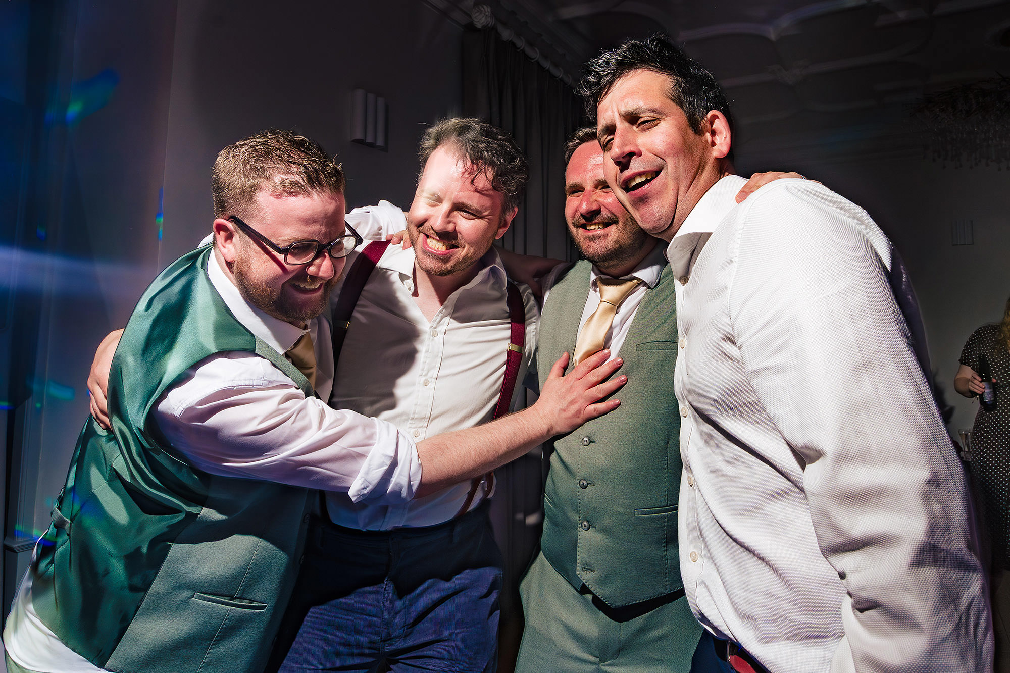 A group of friends singing along together on the dance floor at a Salt House wedding party