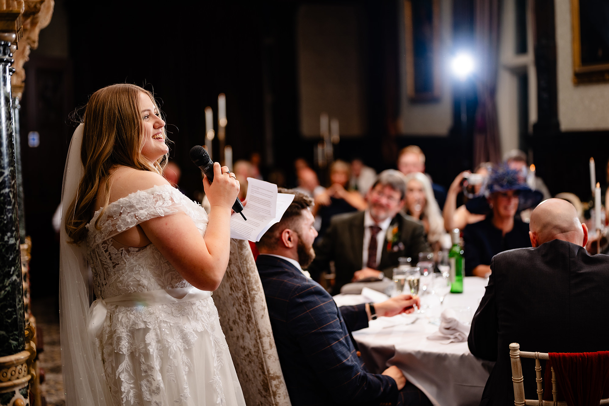 Annie giving her own speech, microphone in hand, at Crewe Hall, Cheshire wedding photographer