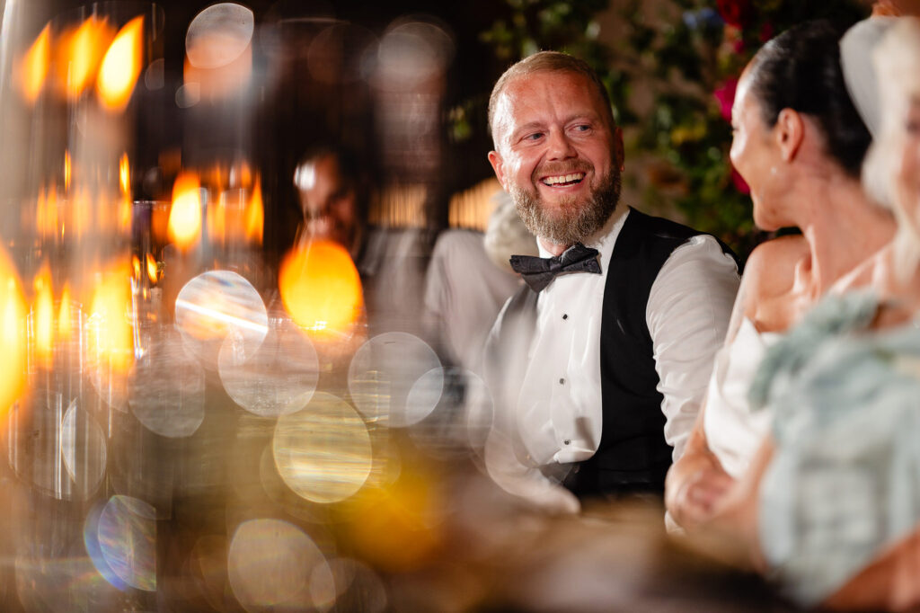 Glynn laughing at the top table during the speeches, Swancar Farm wedding photographer
