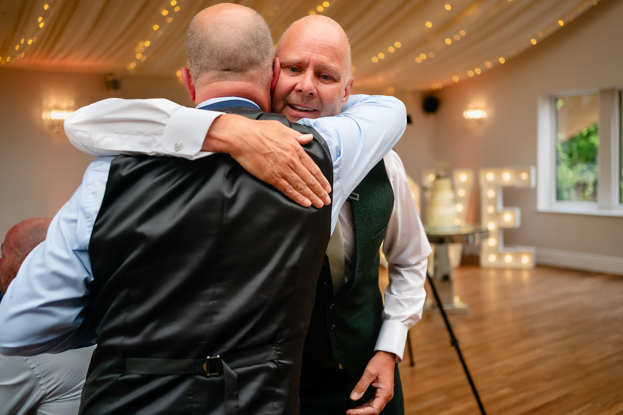 A big hug between two guests during the wedding speeches