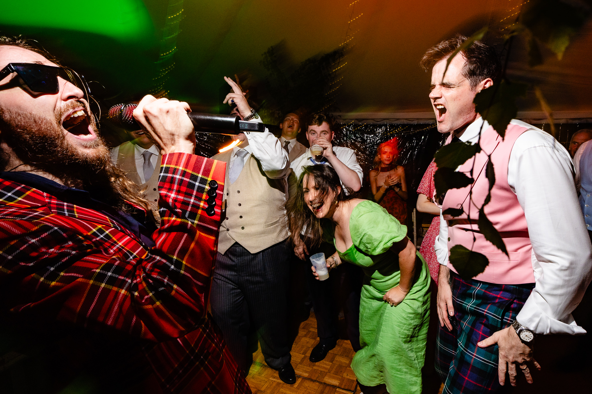 Band’s singer down in the crowd with guests during the last set, Dorset marquee wedding photographer