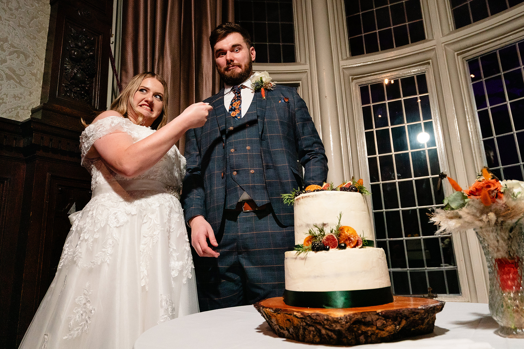 Annie and Tom cutting their wedding cake at Crewe Hall, Cheshire wedding photographer