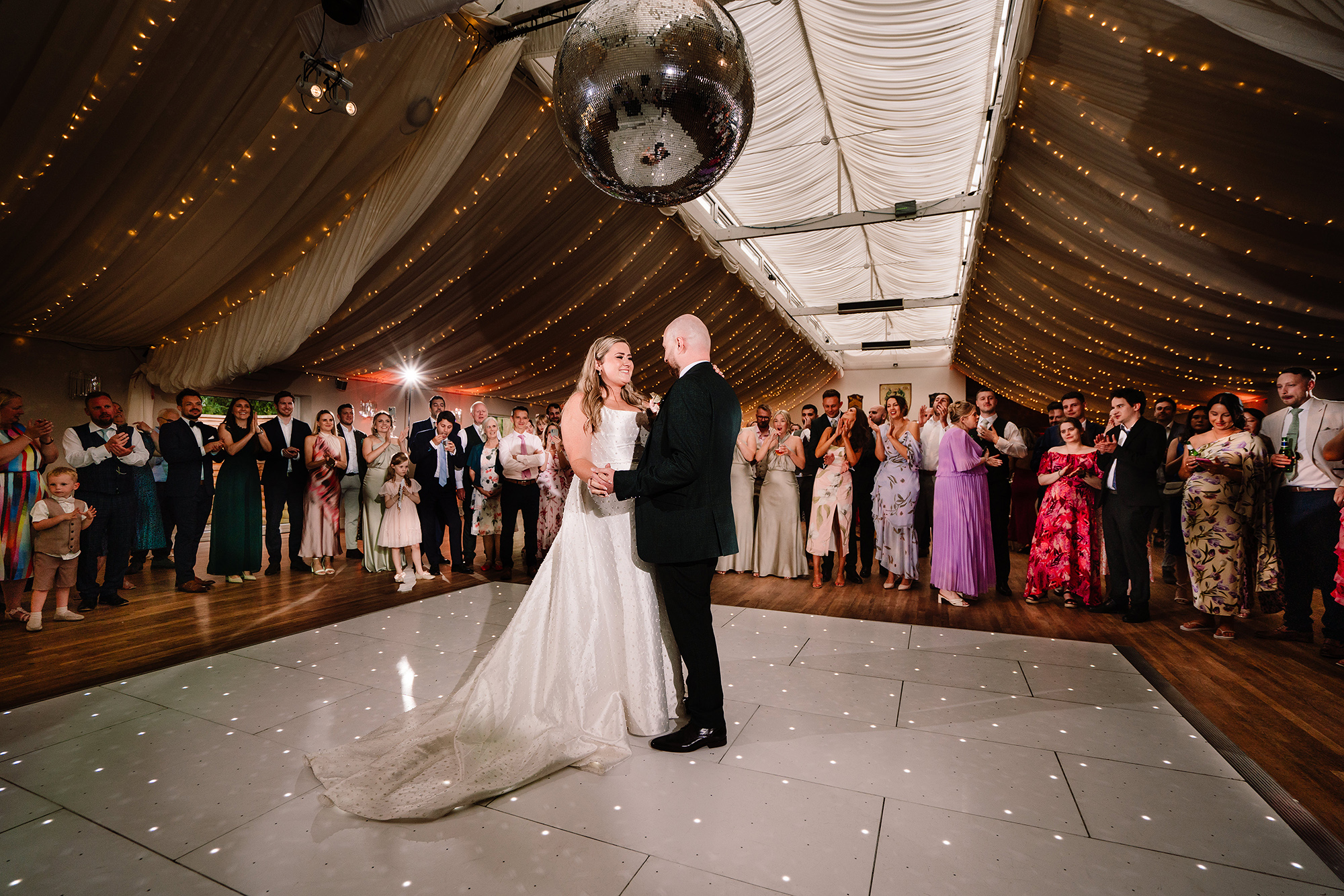 Chloe and Pete’s first dance beginning on the marquee dancefloor at Wrenbury Hall