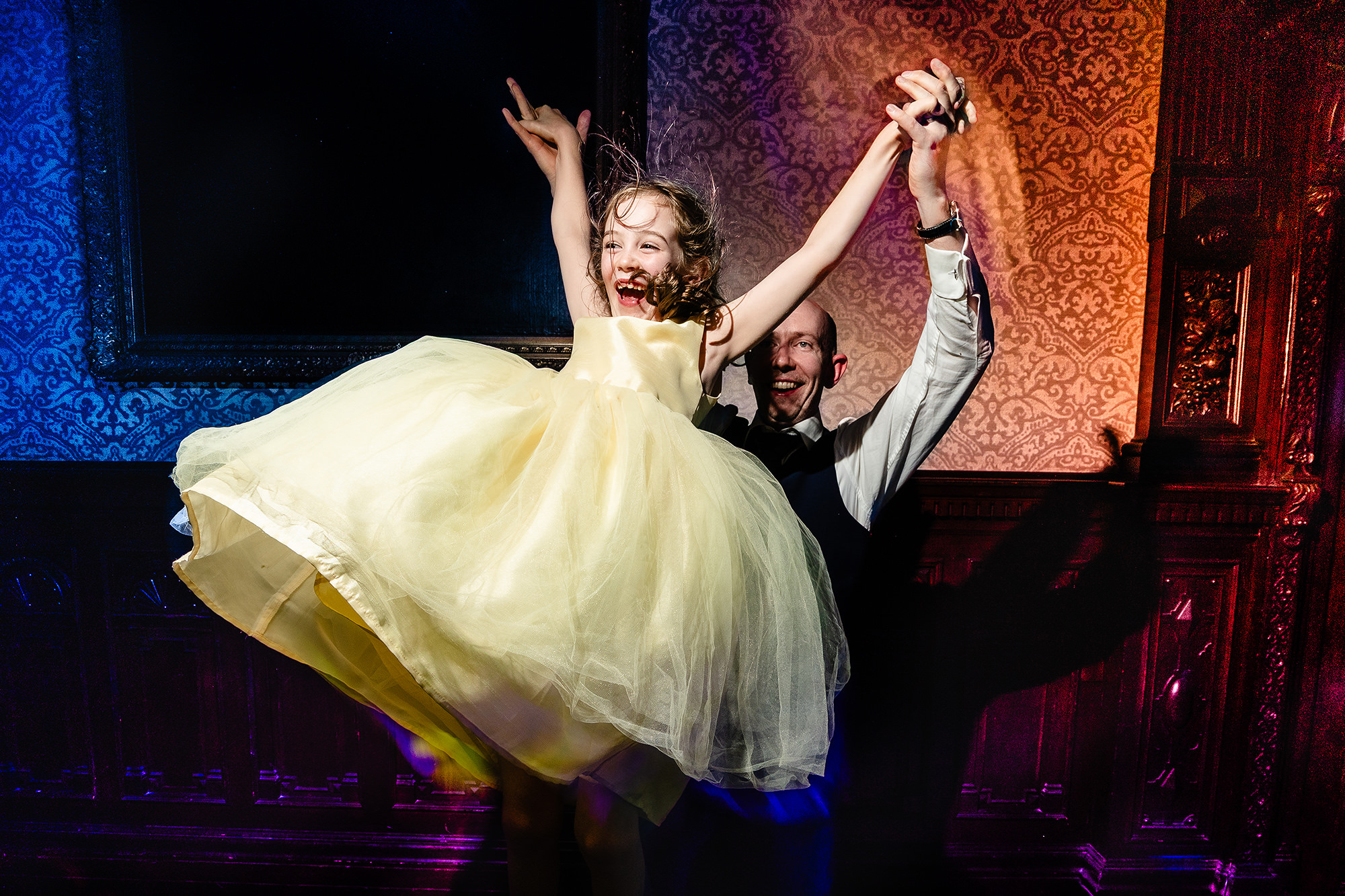 A guest being twirled joyfully on the dancefloor at Crewe Hall, Cheshire wedding photographer