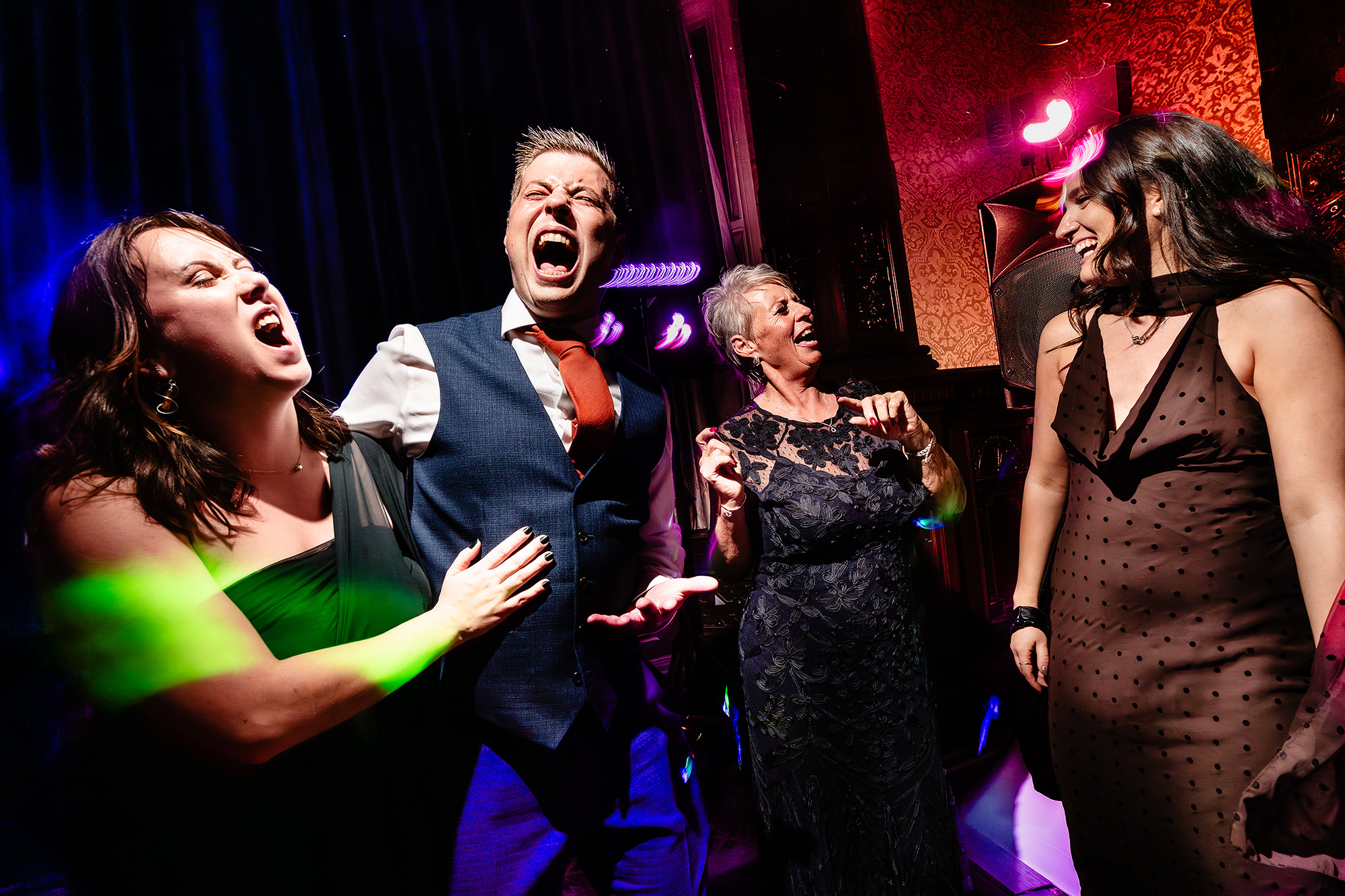 Guests singing along and dancing during the evening party at Crewe Hall, Cheshire wedding photographer