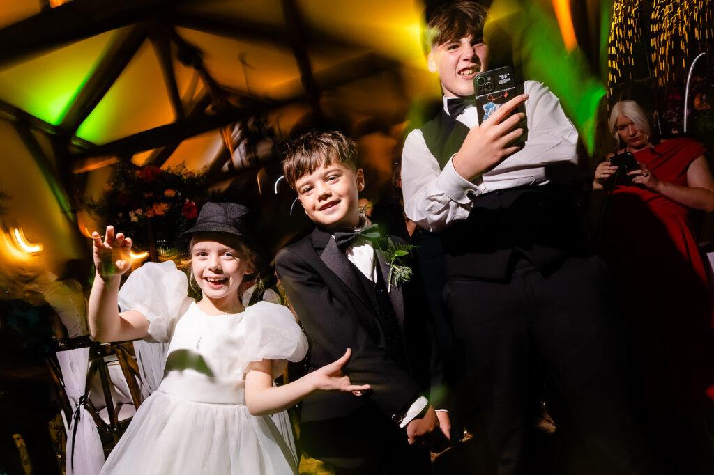Flower girl and two boys dancing at the evening party, Nottingham wedding photographer