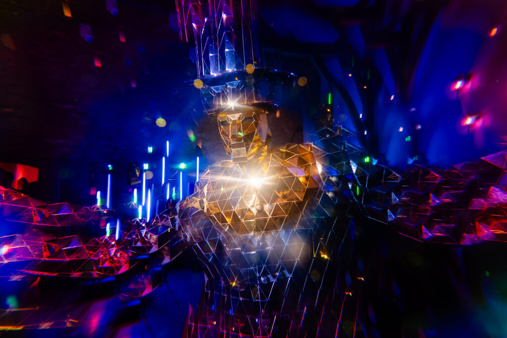 A mirror man entertainer reflecting the dance floor lights, Swancar Farm wedding photographer
