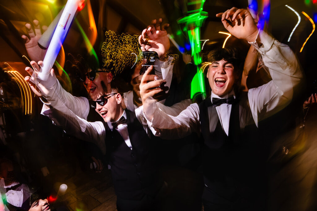 Guests dancing with light sticks and phones in the air, Nottingham wedding photographer