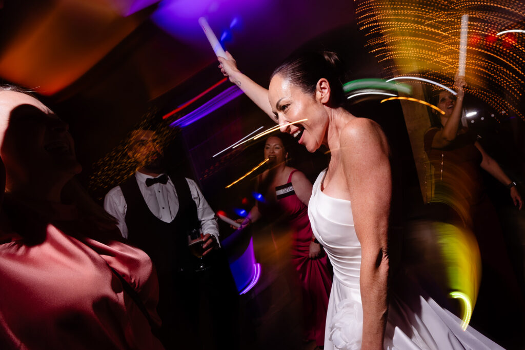 Kim dancing with streaks of coloured light around her, Nottingham wedding photographer