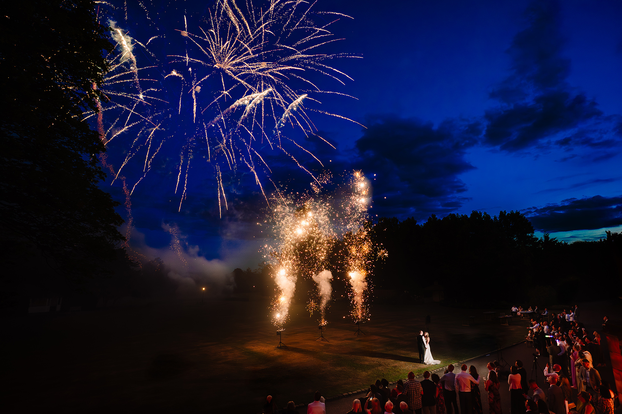A wide view of the fireworks over Wrenbury Hall’s grounds, taken from the top floor of the hall with guests watching below