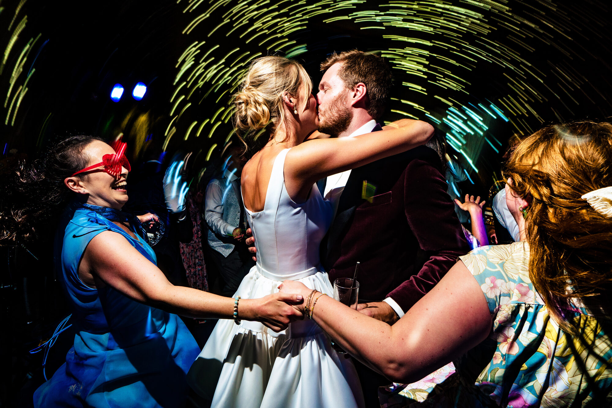 Bride and groom kissing in the middle of the dance floor