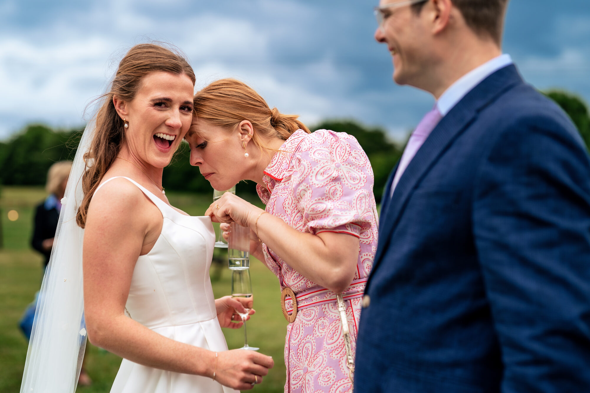 Bride laughing with her friends on the wedding day