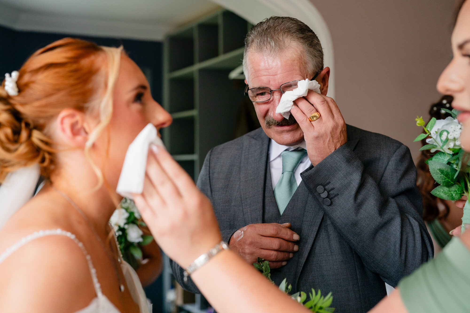 Father of the bride wiping away tears on the wedding day