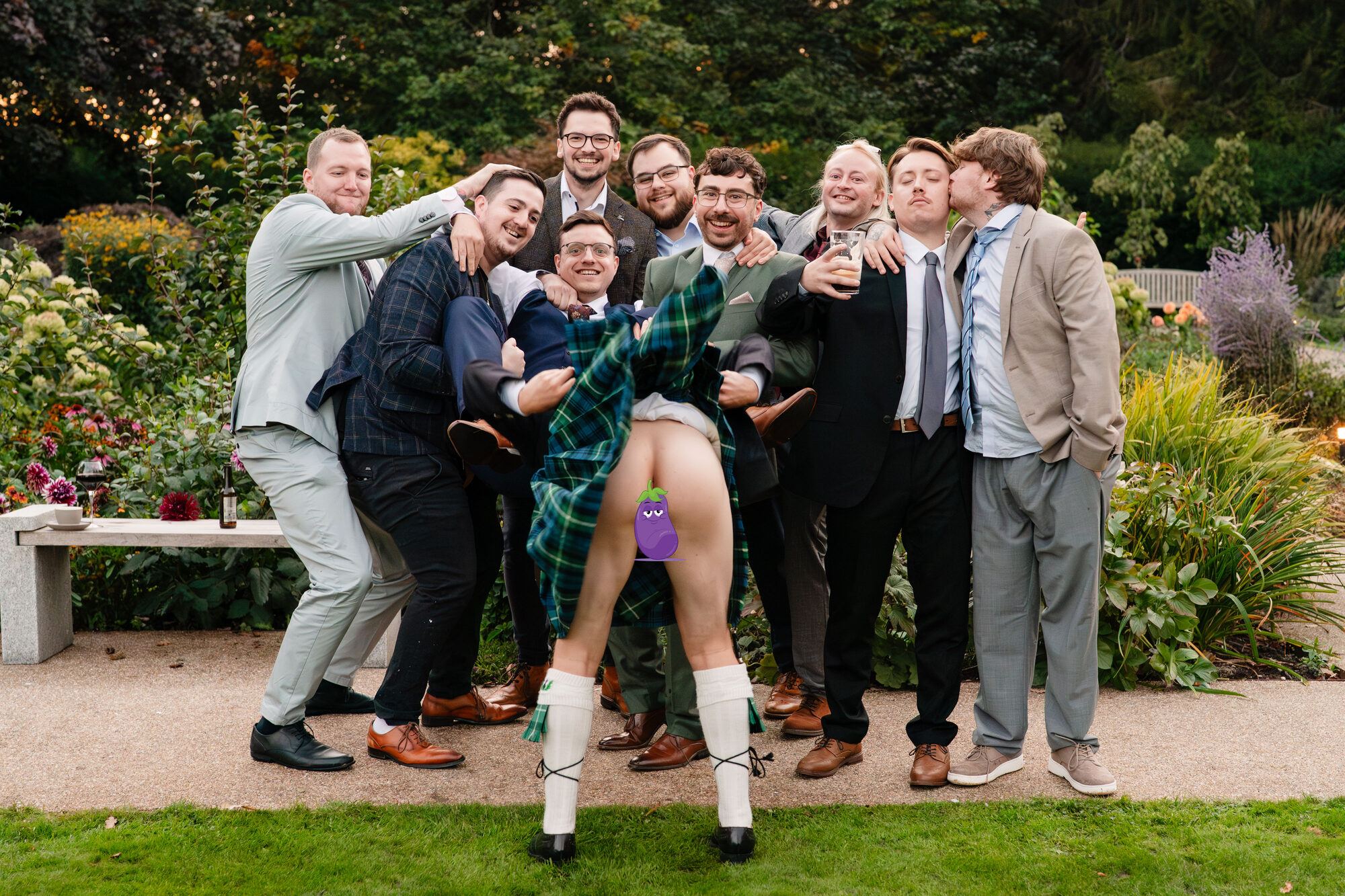 Groomsmen larking about during the group photographs