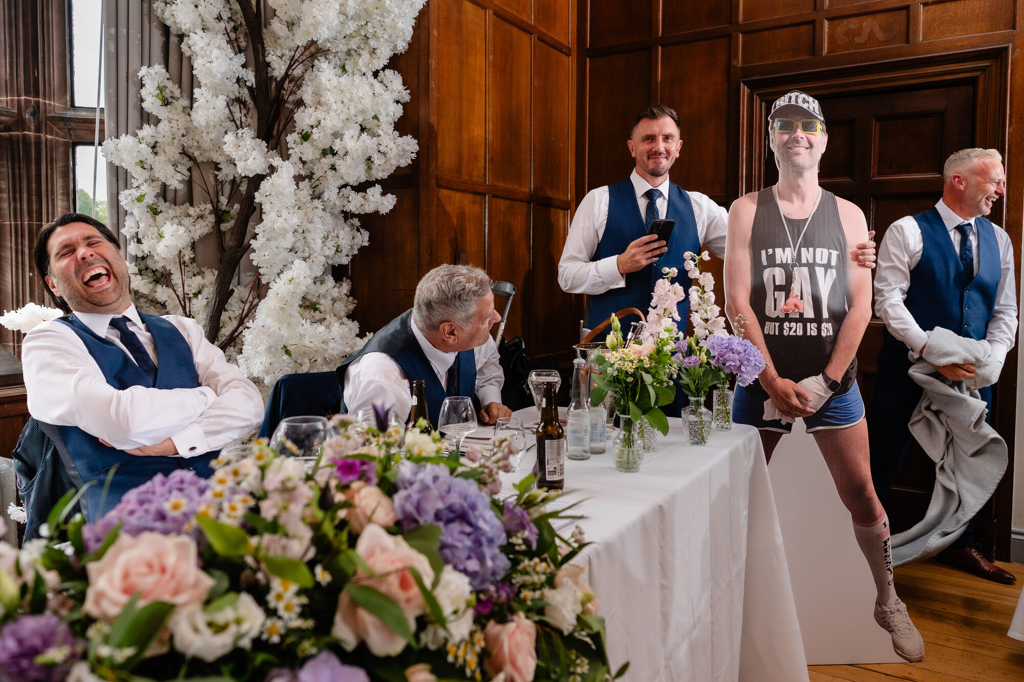 Guests laughing at a surprise during the wedding speeches