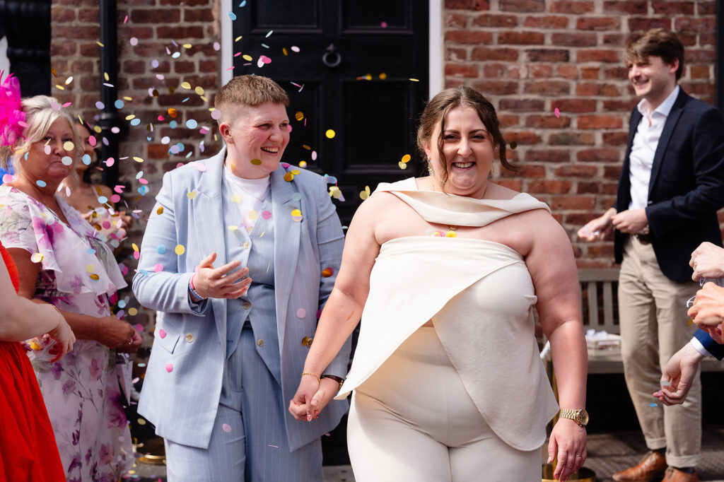 Marianne and Emma laughing together with confetti still in the air