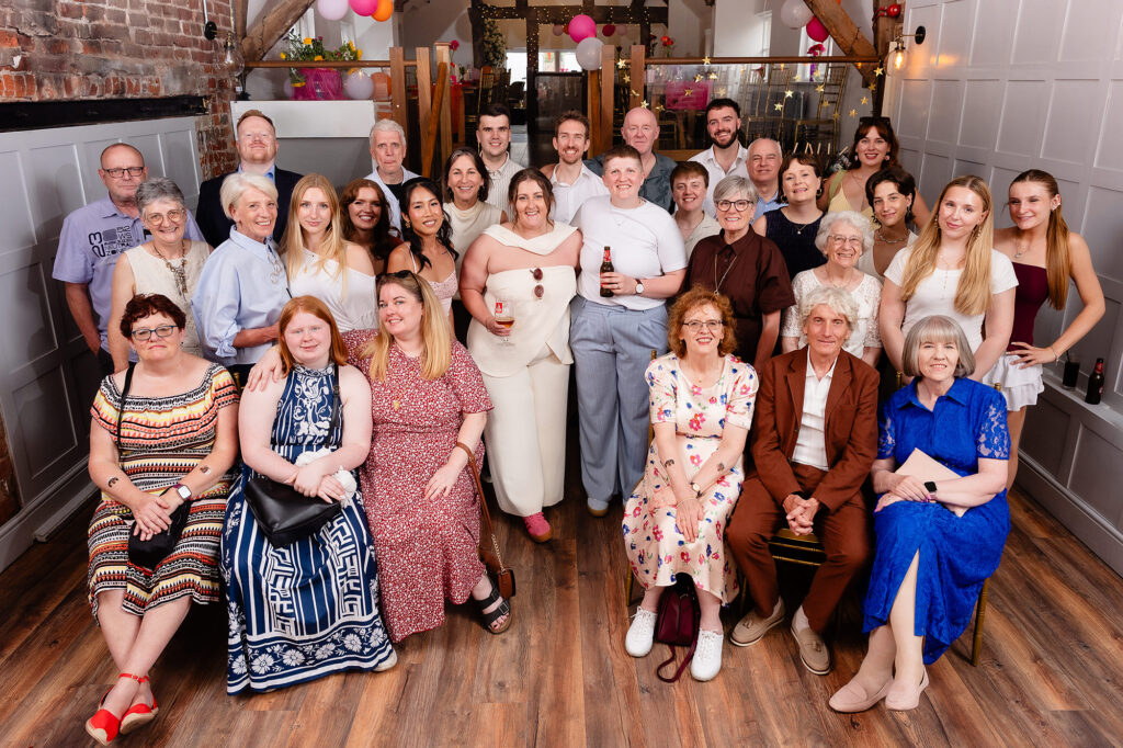 Large family group photo with Marianne and Emma inside The Hidden Barn @ 94