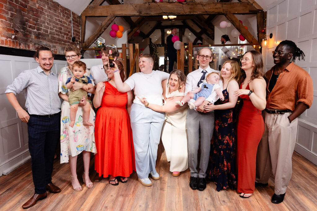 Group of friends laughing with Marianne and Emma at their Knutsford wedding
