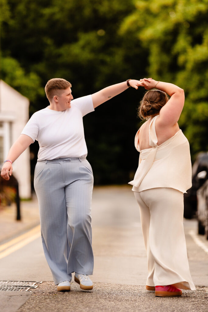 Marianne twirling Emma in the road, Knutsford wedding photographer