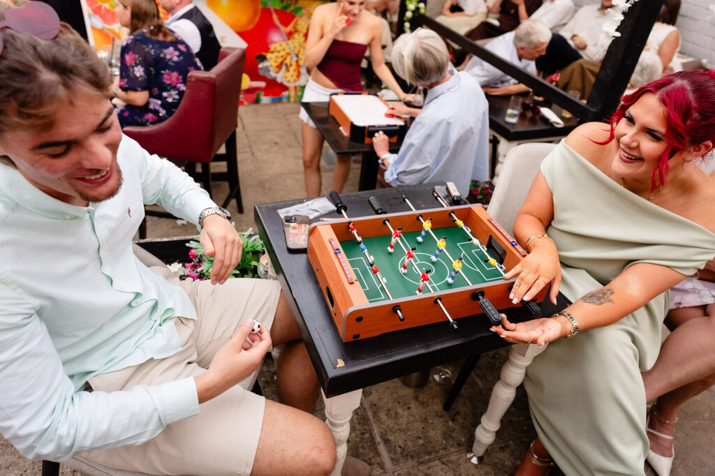 Guests playing table football at The Hidden Barn @ 94