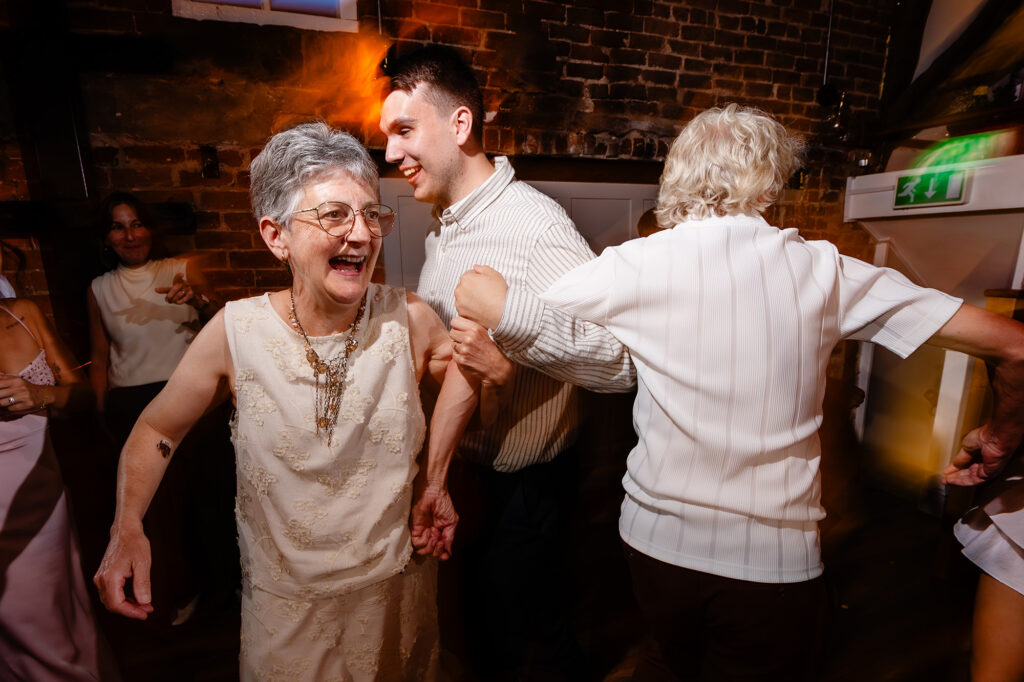Guests dancing arm in arm on the dance floor at The Hidden Barn @ 94