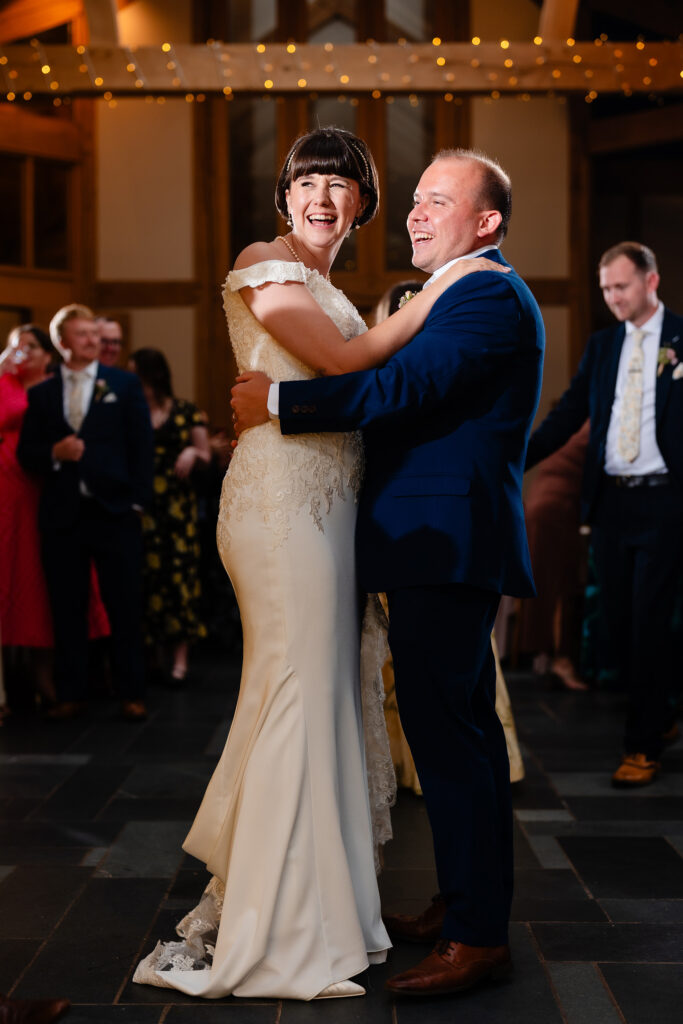 Bride and groom laughing during their first dance, Cheshire wedding photographer